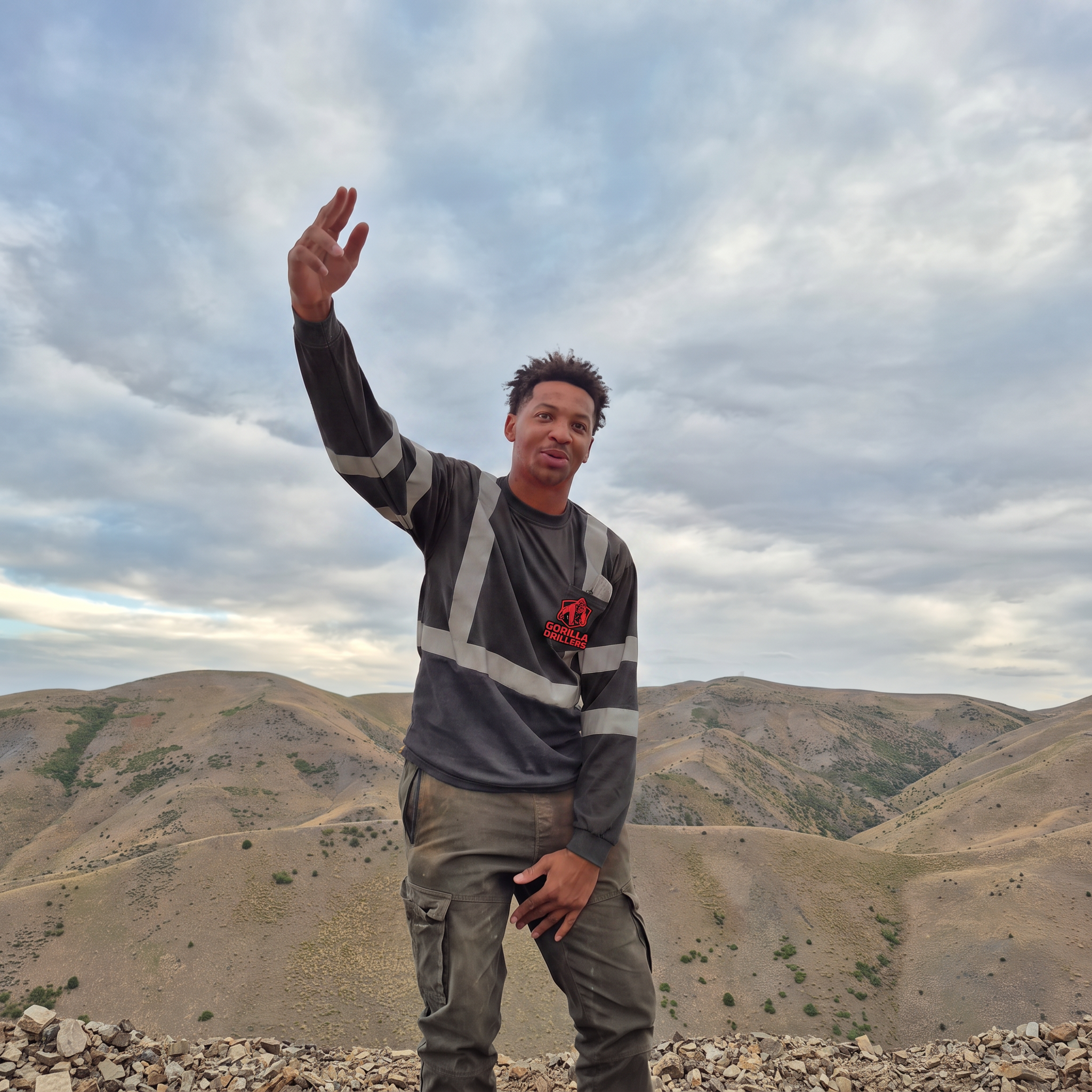 Mikal E., Gorilla Drillers helper, on a Nevada ridge pad in company uniform